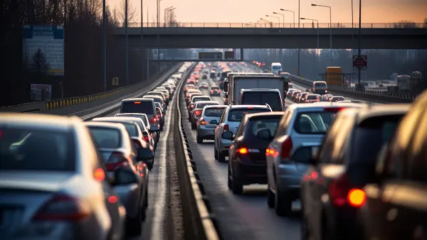 Heavy traffic at standstill on freeway at dusk.