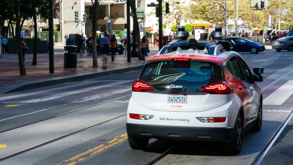 Red and white Cruise autonomous Chevy Bolt on San Francisco street
